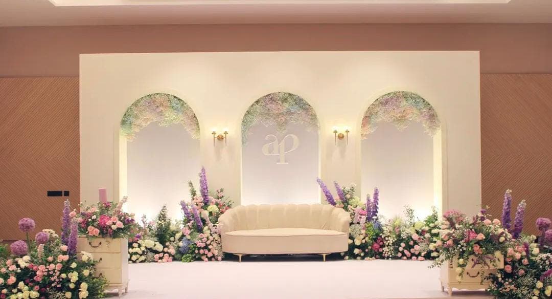 Soft arch lavender stage with floral arrangements